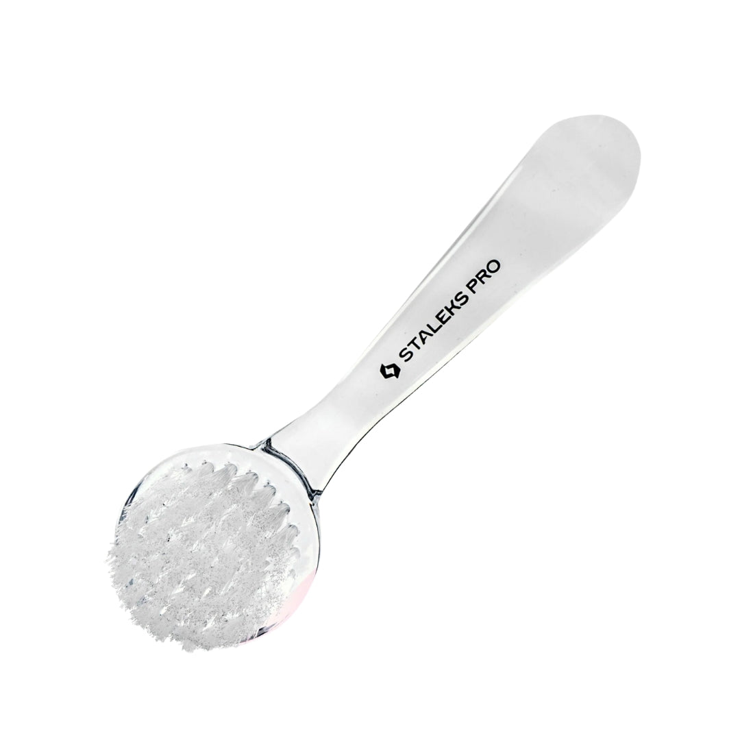 Durable nail cleaning brush with synthetic bristles, curved handle, protective cap, and compact design for easy use and transport.