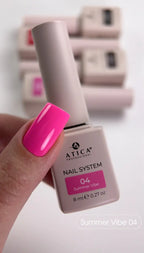 Atica nail polish bottle with a hand holding a pink nail, set against a blurred background of more nail polishes.