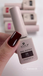 Atica Professional nail polish bottle with a hand showing a dark red nail color.