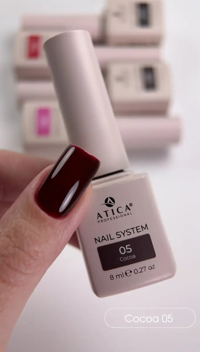 Atica Professional nail polish bottle with a hand showing a dark red nail color.