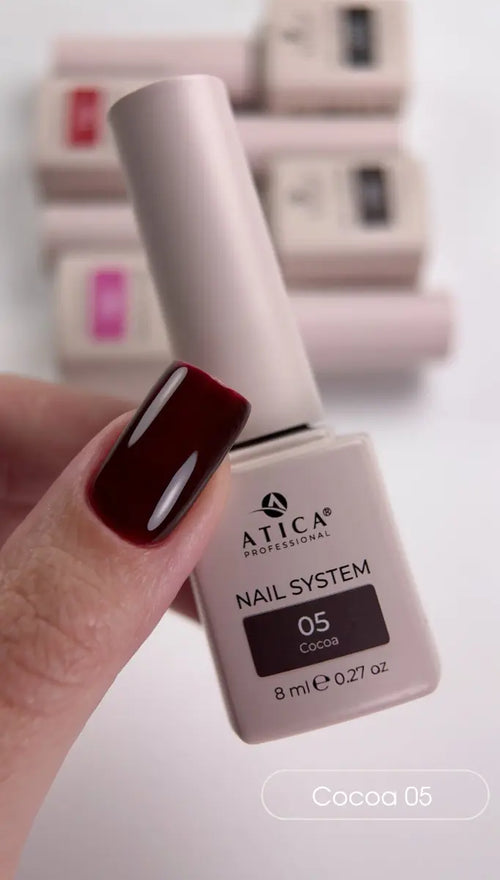 Atica Professional nail polish bottle with a hand showing a dark red nail color.