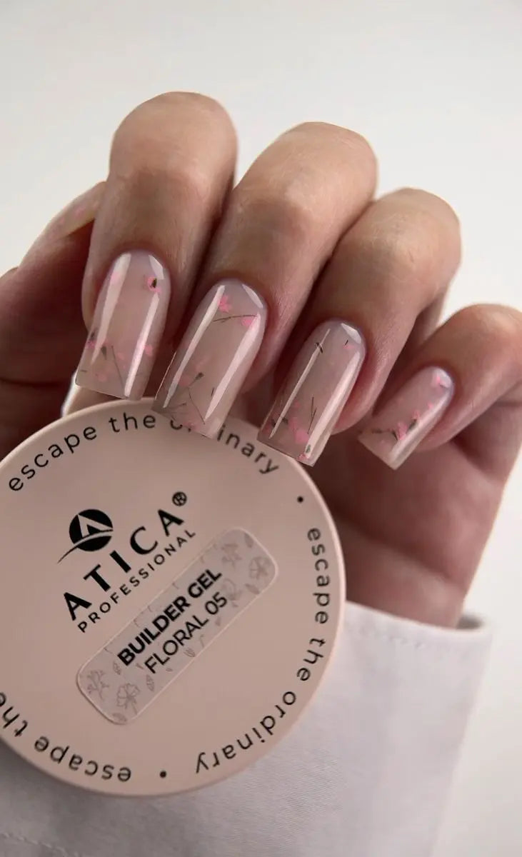 Hand with pink nail polish holding a container of Atica Professional Builder Gel Floralos.