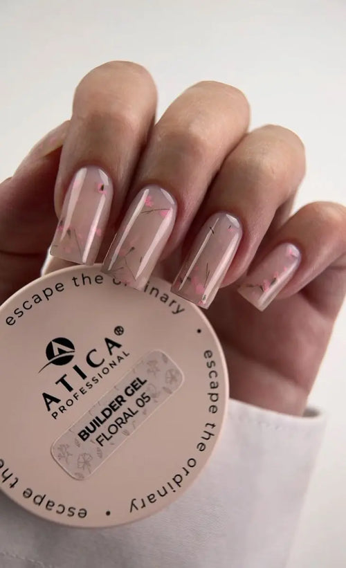 Hand with pink nail polish holding a container of Atica Professional Builder Gel Floralos.