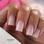 Nail polish with EXEL Builder Gel 06 FOG on a blurred background
