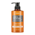 A bottle of KUNDAL Honey & Macadamia Body Wash in Amber Vanilla scent, featuring an amber-colored translucent bottle with a black pump dispenser and a gray and white label.