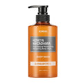 A bottle of KUNDAL Honey & Macadamia Body Wash in the English Rose scent, featuring an amber-colored bottle with a black pump dispenser and a gray label.
