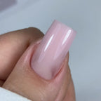 Close-up of a hand with a almond nail on a light background
