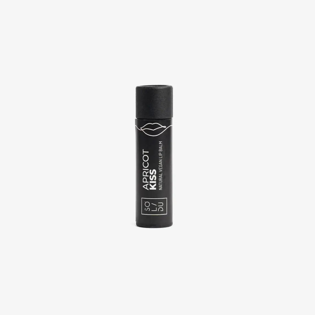 Black lip balm with 'Apricot Kiss' text on a white background