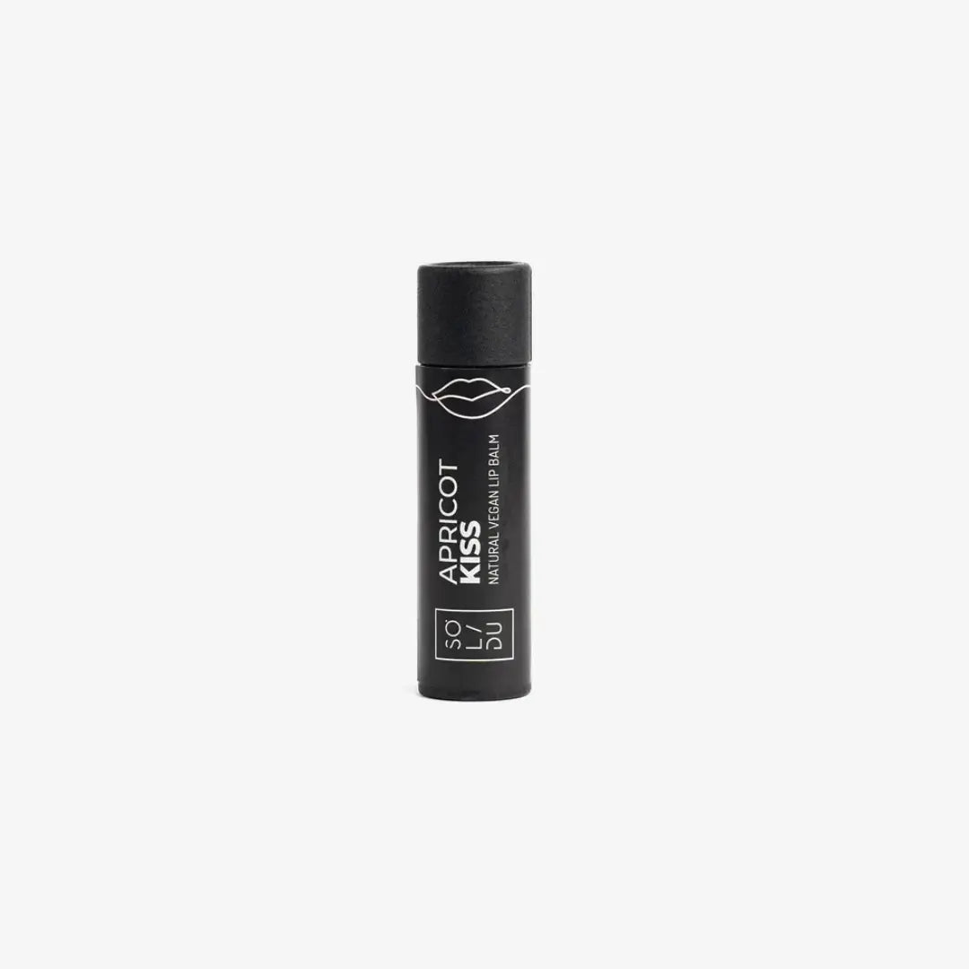 Black lip balm with 'Apricot Kiss' text on a white background