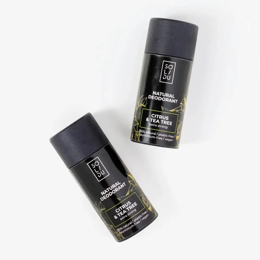 Two black natural deodorants with green text on a white background