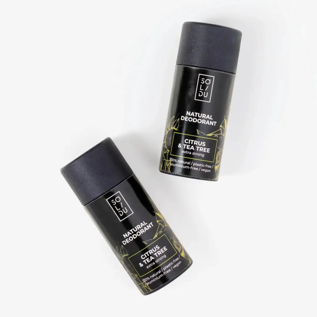 Two black natural deodorants with green text on a white background