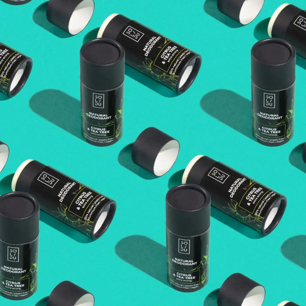 Pattern of black and green cylindrical containers on a teal background