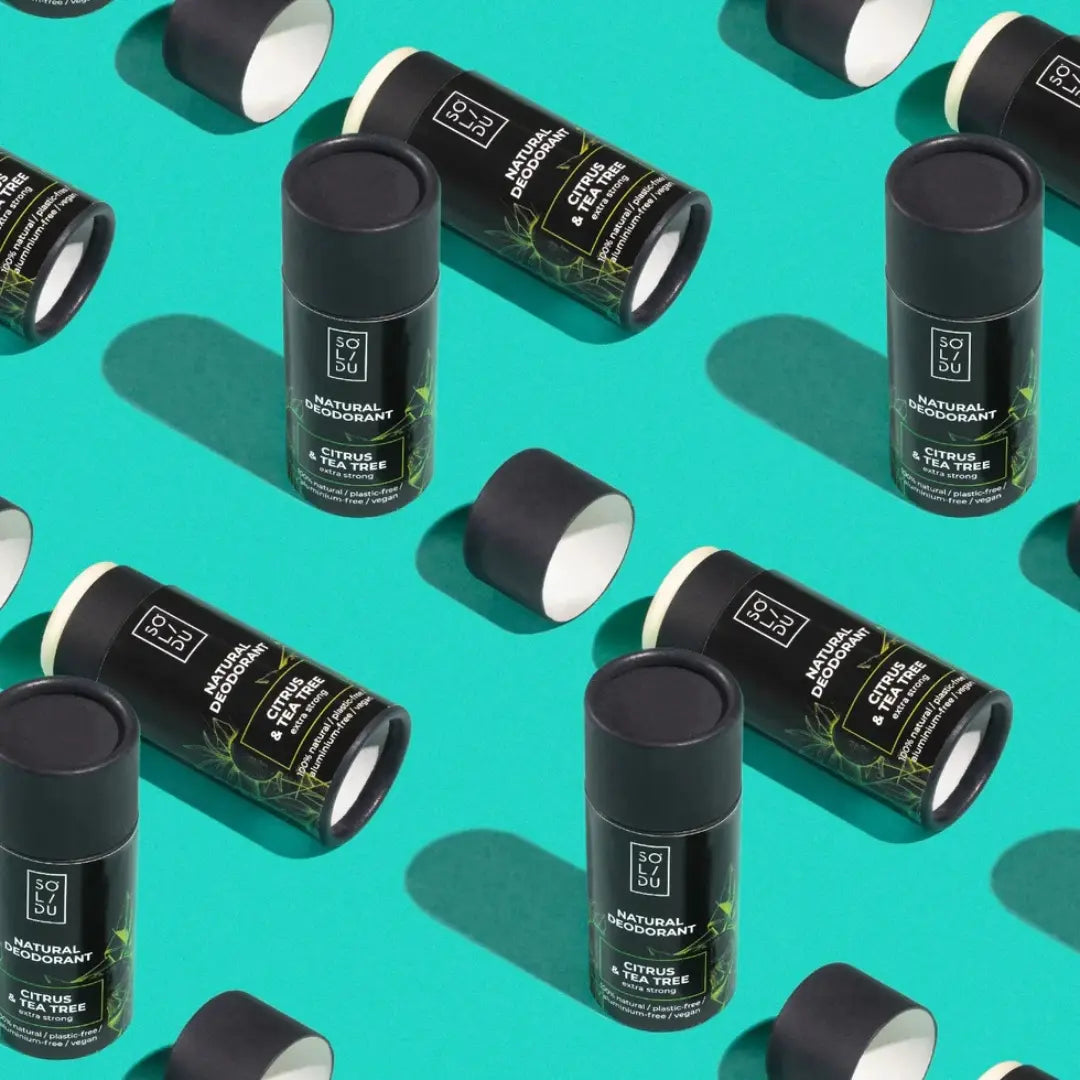 Pattern of black and green cylindrical containers on a teal background