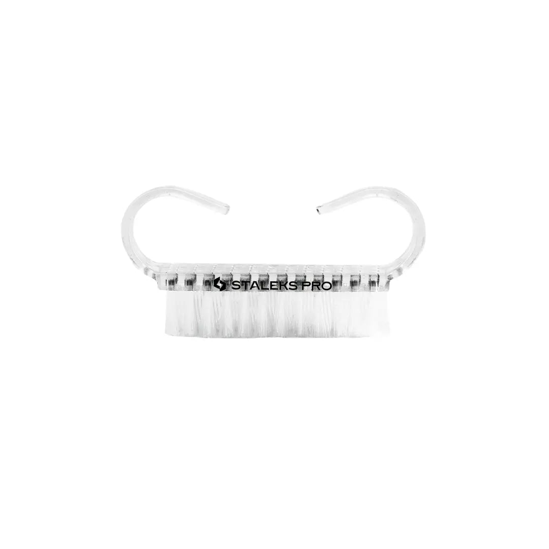 Closeup of Staleks PRO manicure dust brush showing transparent handle and synthetic bristles