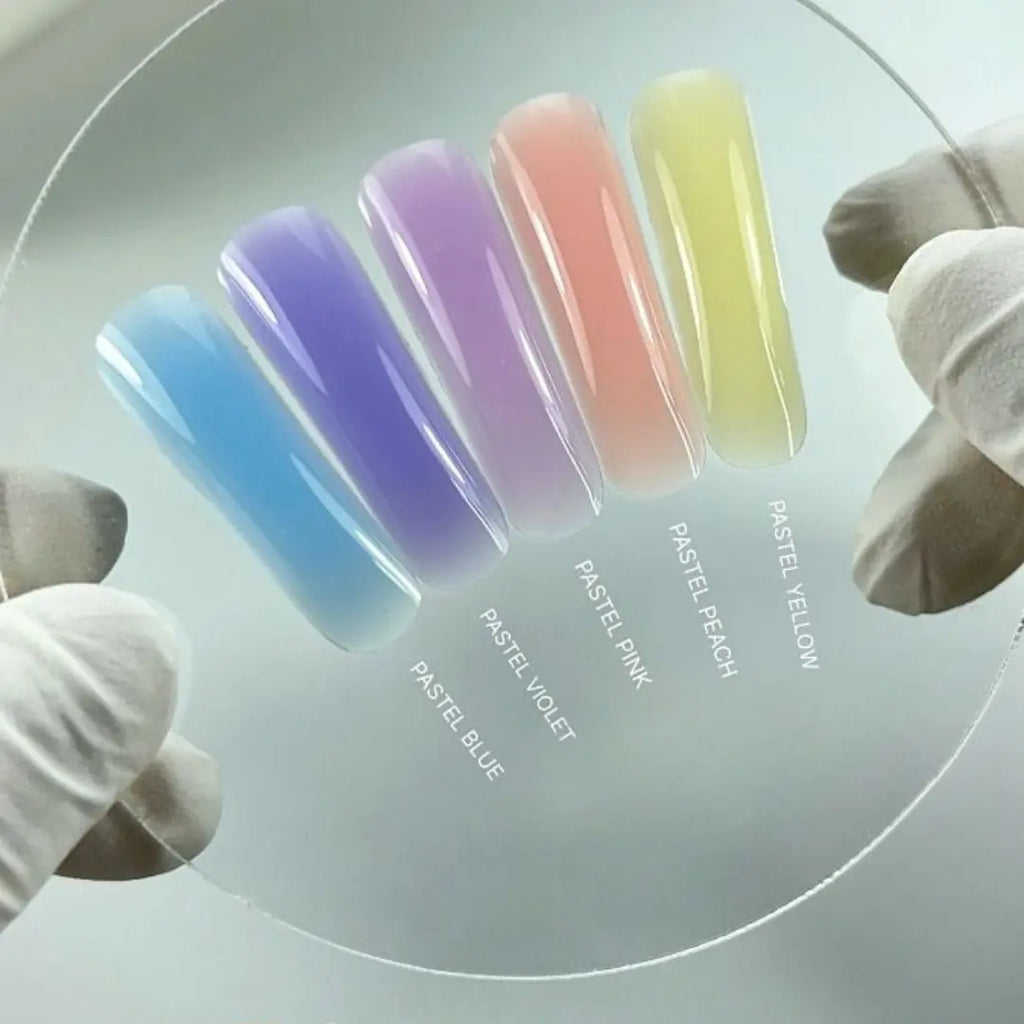Pastel-colored nail polish swatches on a clear background