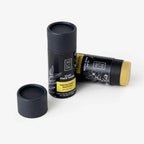 Two black clay face mask tubes with labels on a white background