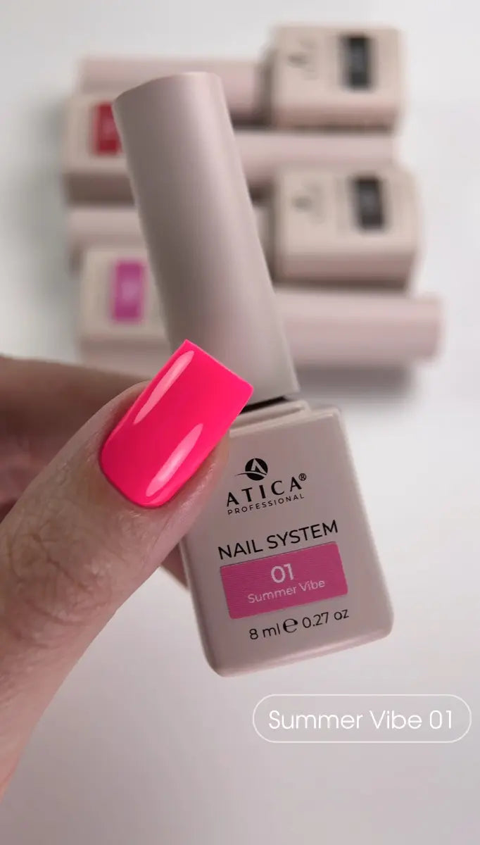 Nail polish bottle with a bright pink nail color on a blurred background