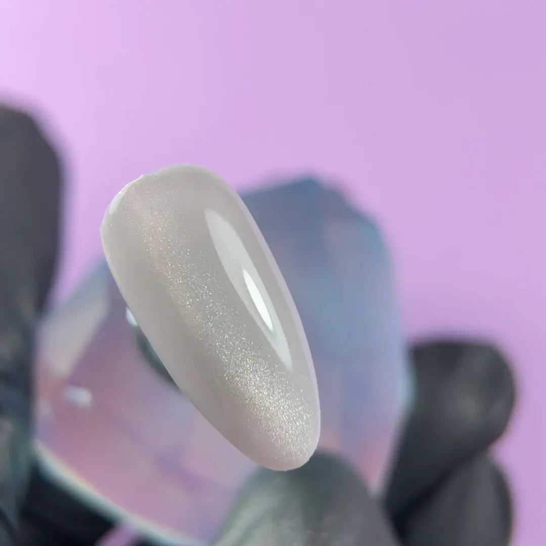 Highly pigmented rich Frosty Silk color with dimensional cat eye magnet effect gel polish swatch closeup
