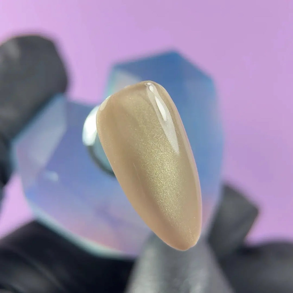 Highly pigmented rich Champagne Silk color with dimensional cat eye magnet effect gel polish swatch closeup