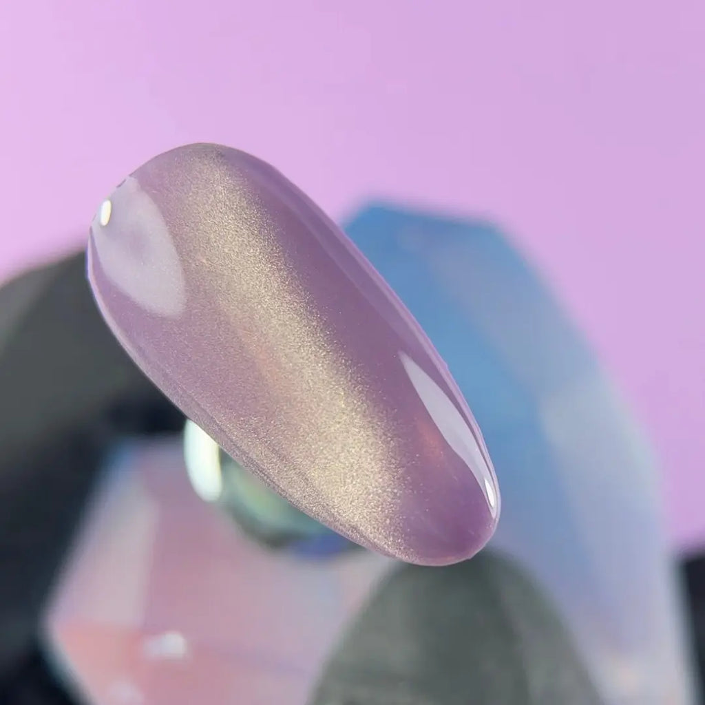 Highly pigmented rich Lavender Silk color with dimensional cat eye magnet effect gel polish swatch closeup