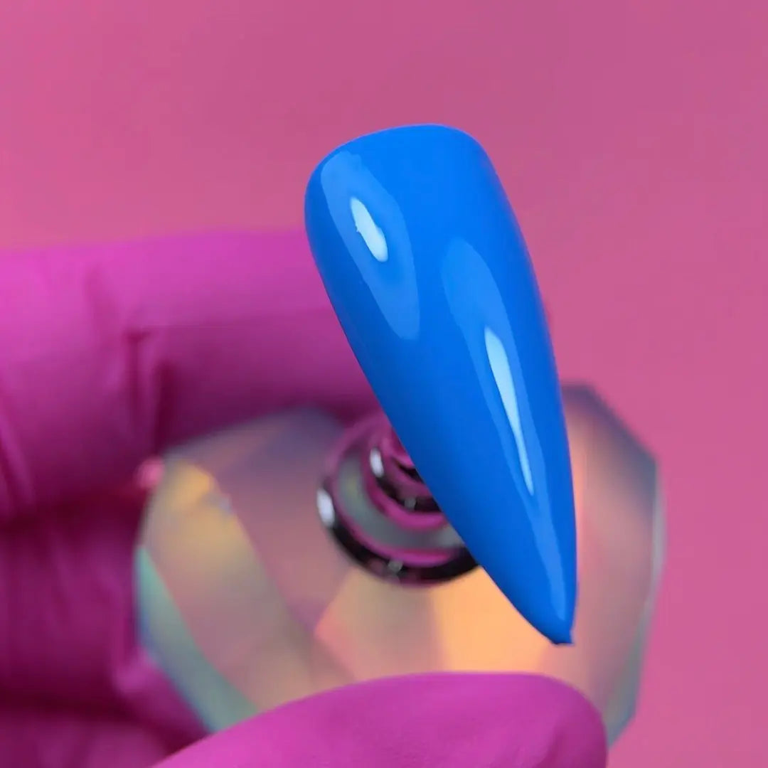Close up of Jelly Gelly Blue Voltage gel polish applied on nail tip showing glossy texture