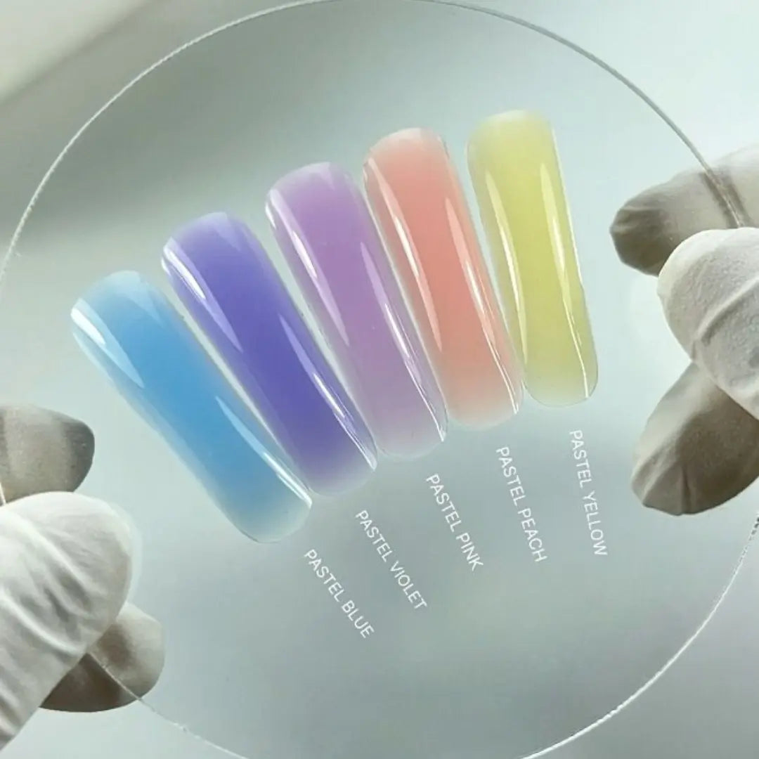 Pastel nail color swatches on a circular tray with labeled colors.