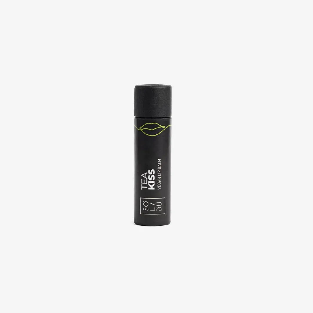 Black lip balm container with 'Tea Kiss' branding on a white background