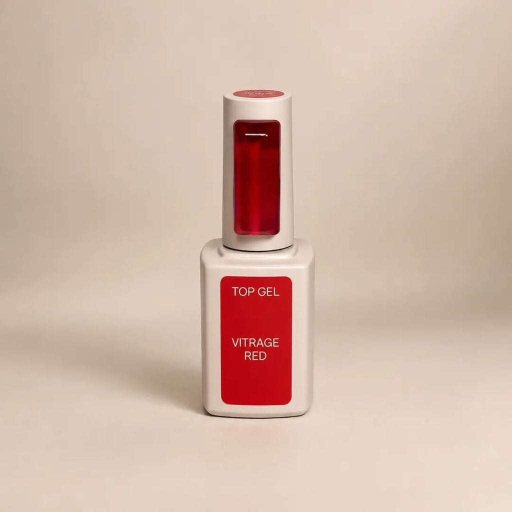 A bottle of Vitrage Red Top Gel nail polish with a white cap and base, featuring a prominent red label and a red gel sample window, set against a warm beige background.