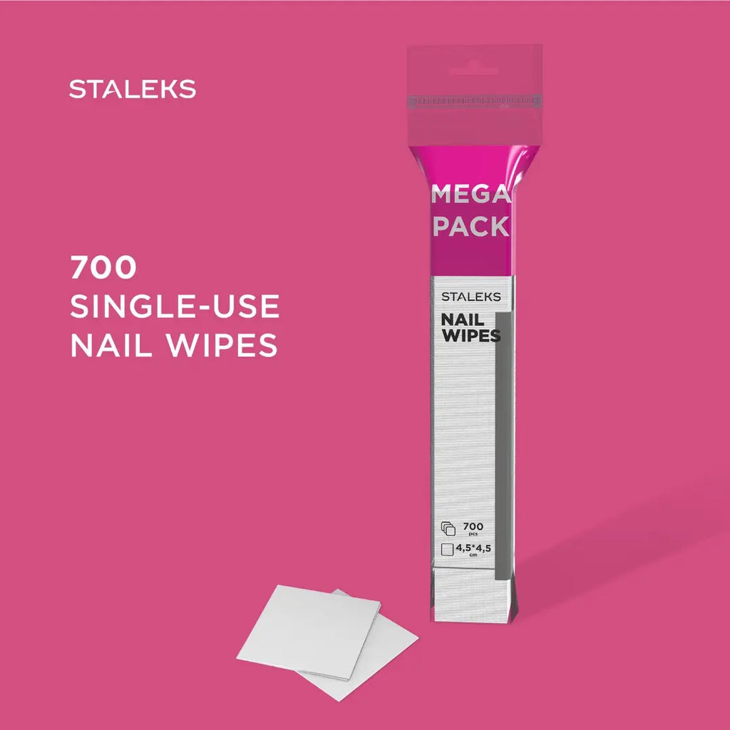 A package of STALEKS Mega Pack single-use nail wipes stands on a pink background with two white wipes placed in front. Text on the image reads 'STALEKS' and '700 SINGLE-USE NAIL WIPES'.